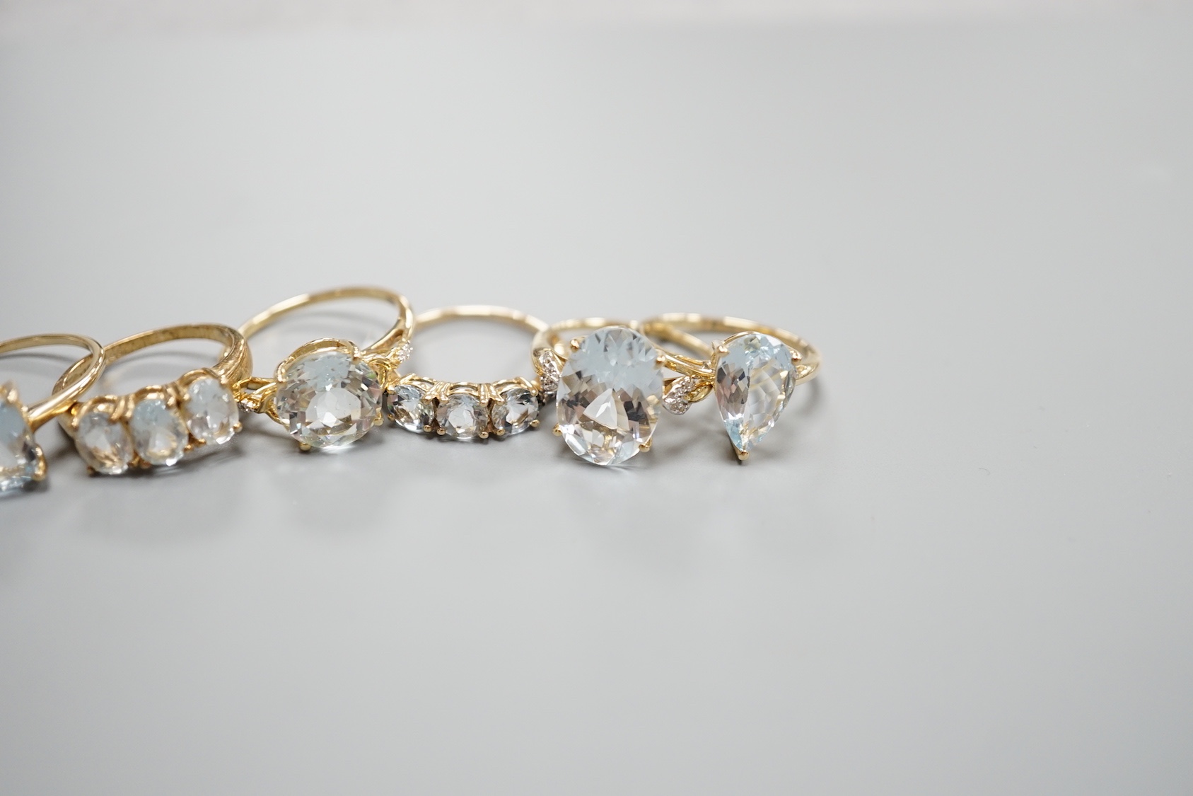 Five assorted modern 9ct gold and aquamarine set dress rings , gross 11.4 grams and one 925 ring.